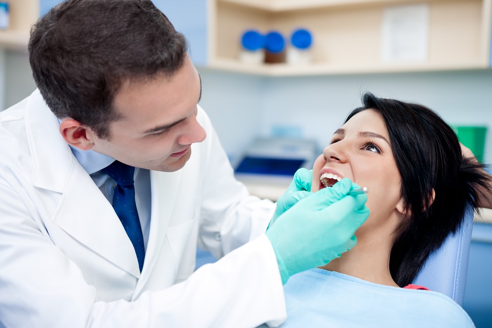 Dentist checking the teeth of the patient