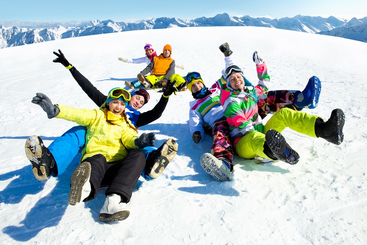 Friends lying on snow