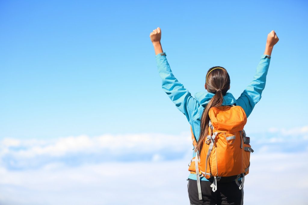 Woman on top of mountain