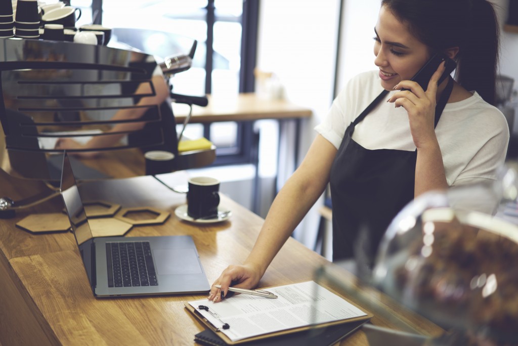 Cafe employee talking over the phone