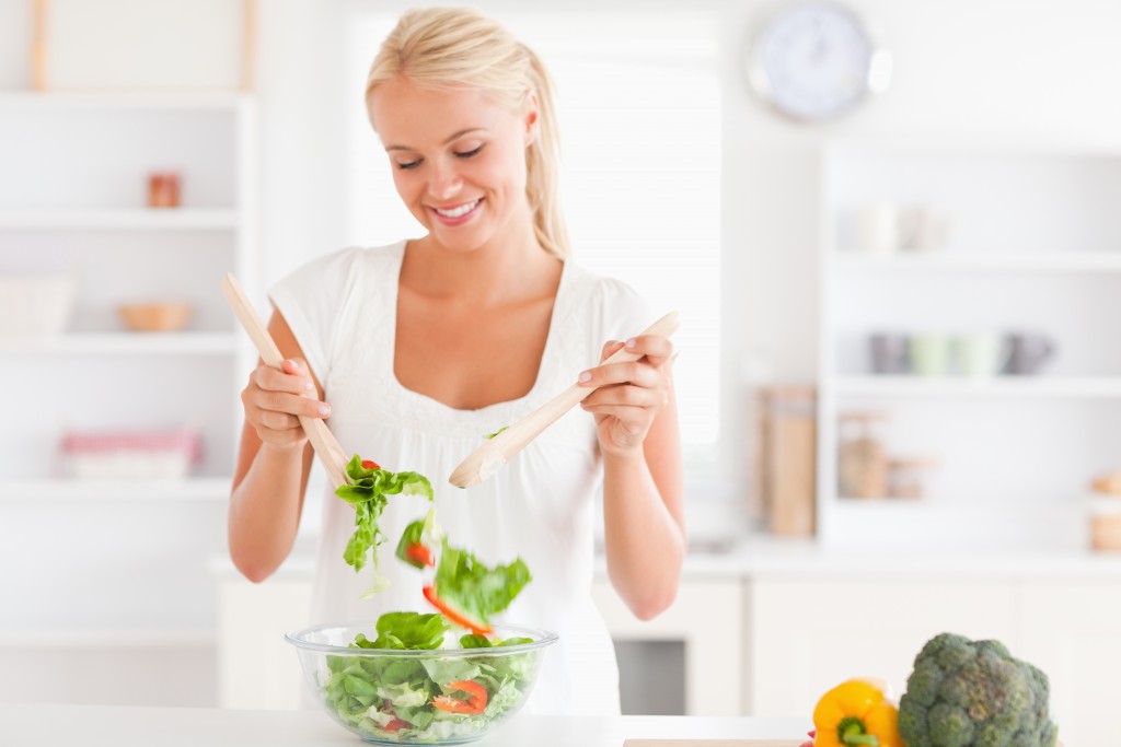 Woman mixing salad