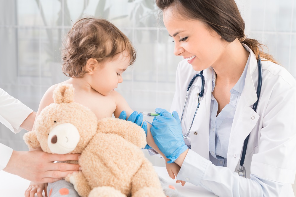 pediatrician injecting vaccine to baby