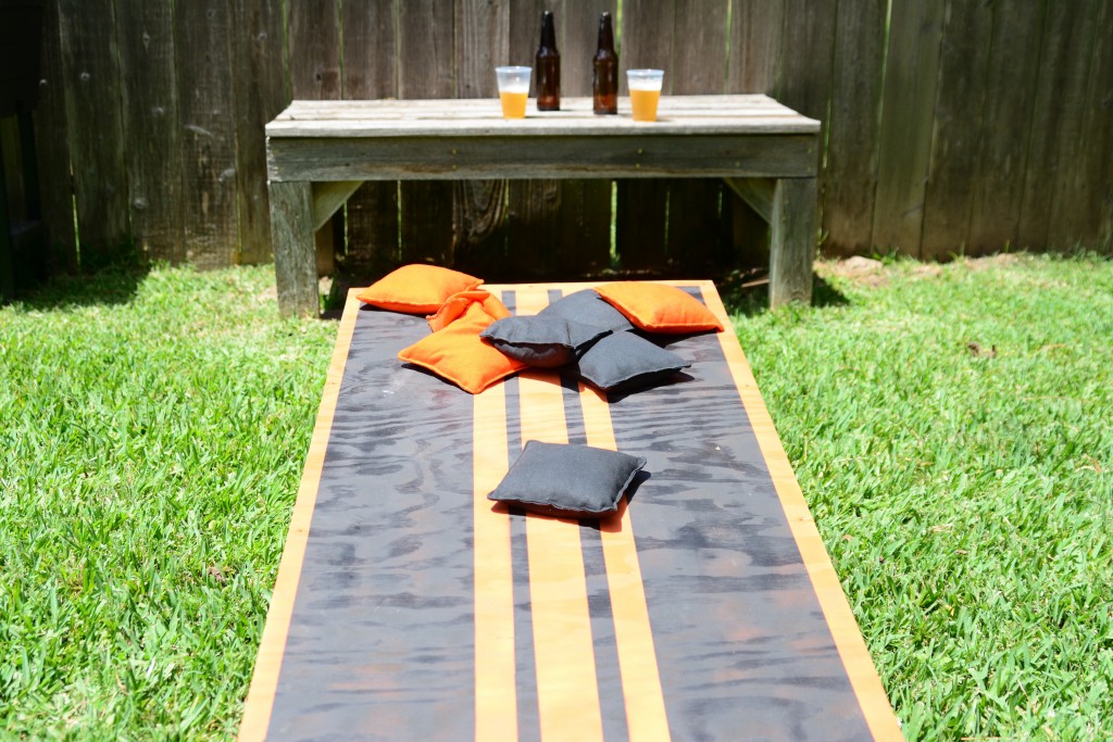 Cornhole lawn game with beer in the bakground