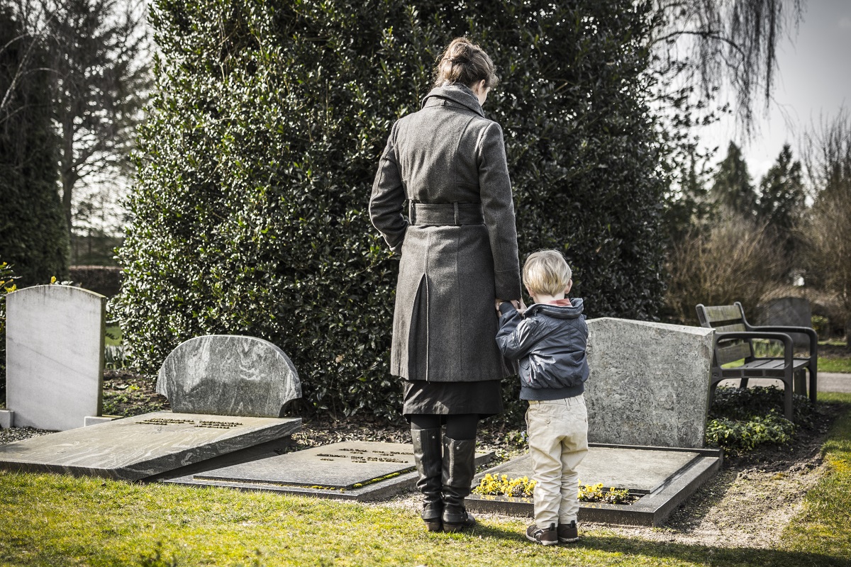 woman and her child at a graveyard