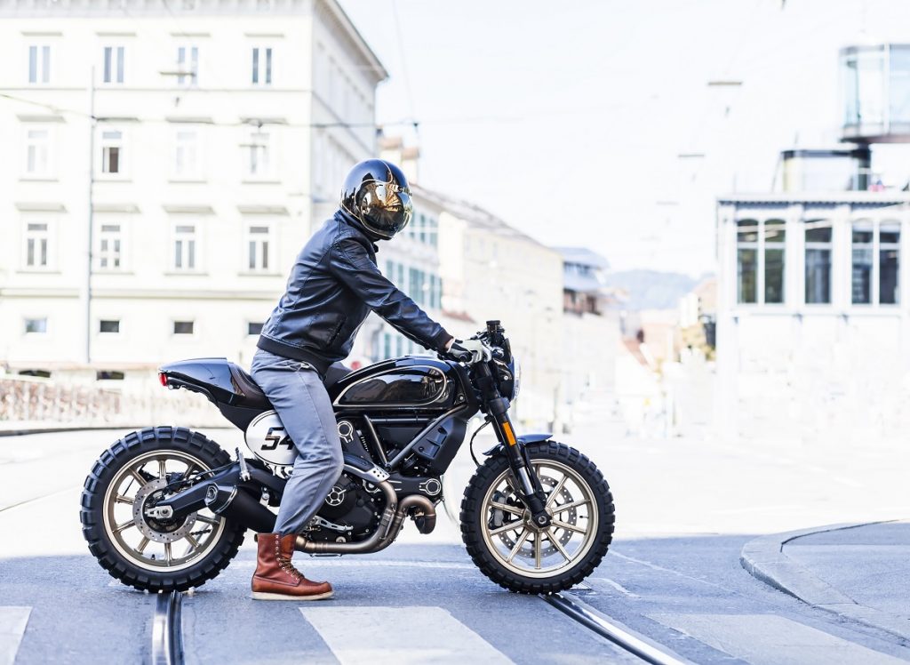 man in wearing black helmet, riding a motorcycle