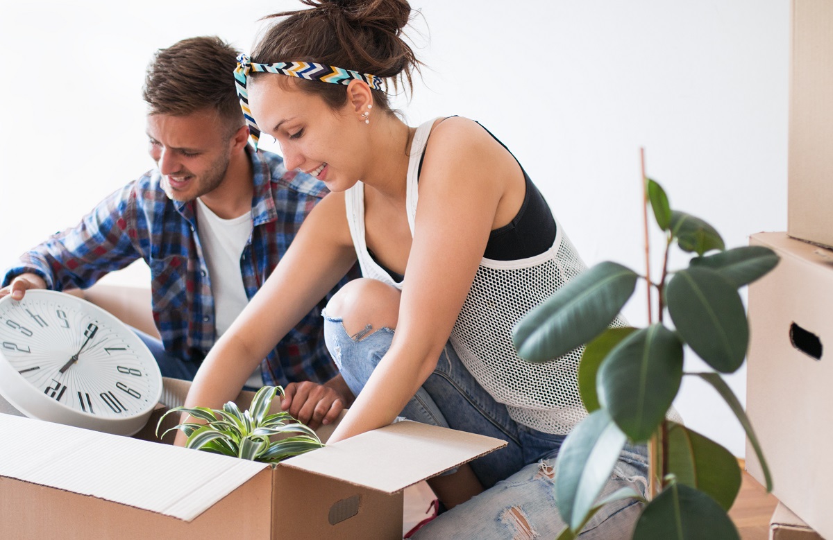 Man and woman packing their items into a box