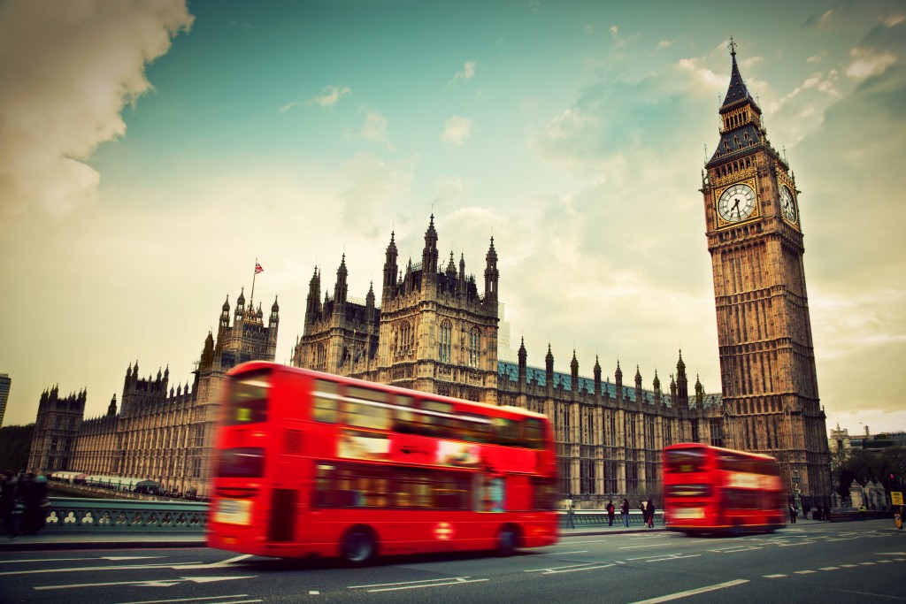 Red bus in motion and Big Ben, the Palace of Westminster