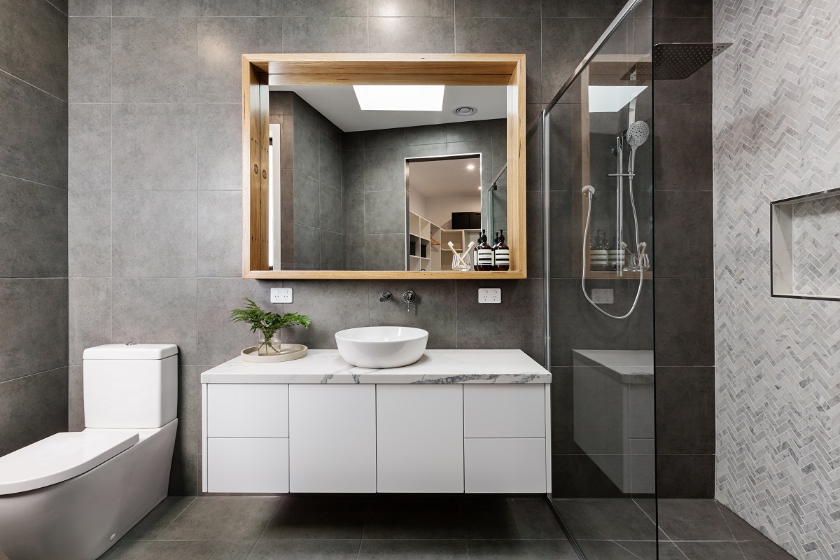 modern bathroom with gray tiles and big mirror