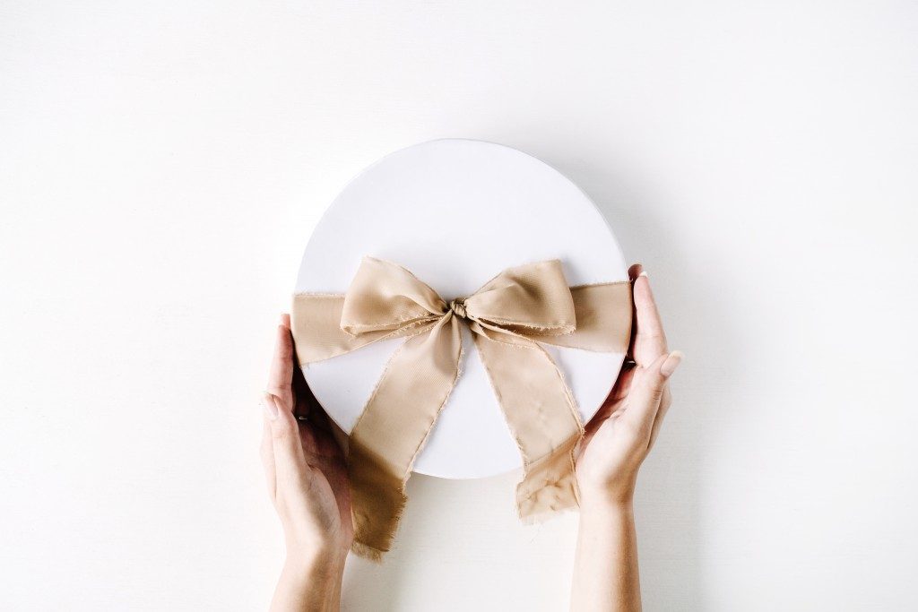 gift packed in a white box and beige ribbon