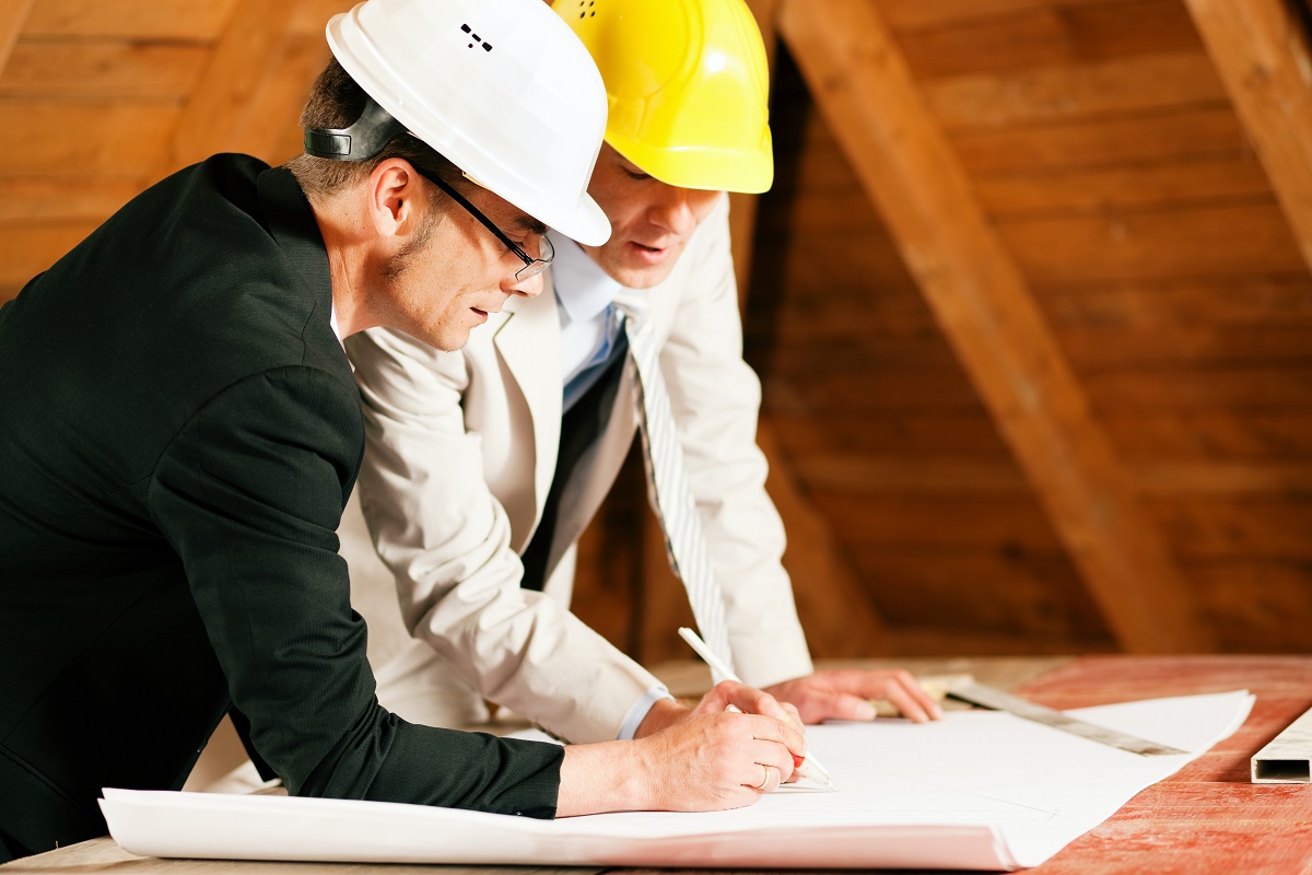 two men looking at a constuction plan