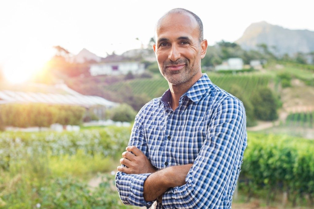 farmer posing near his farm