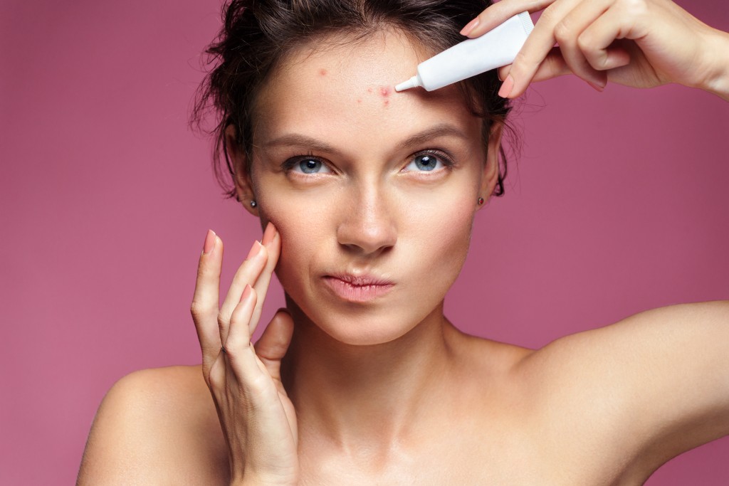 woman treating her acne