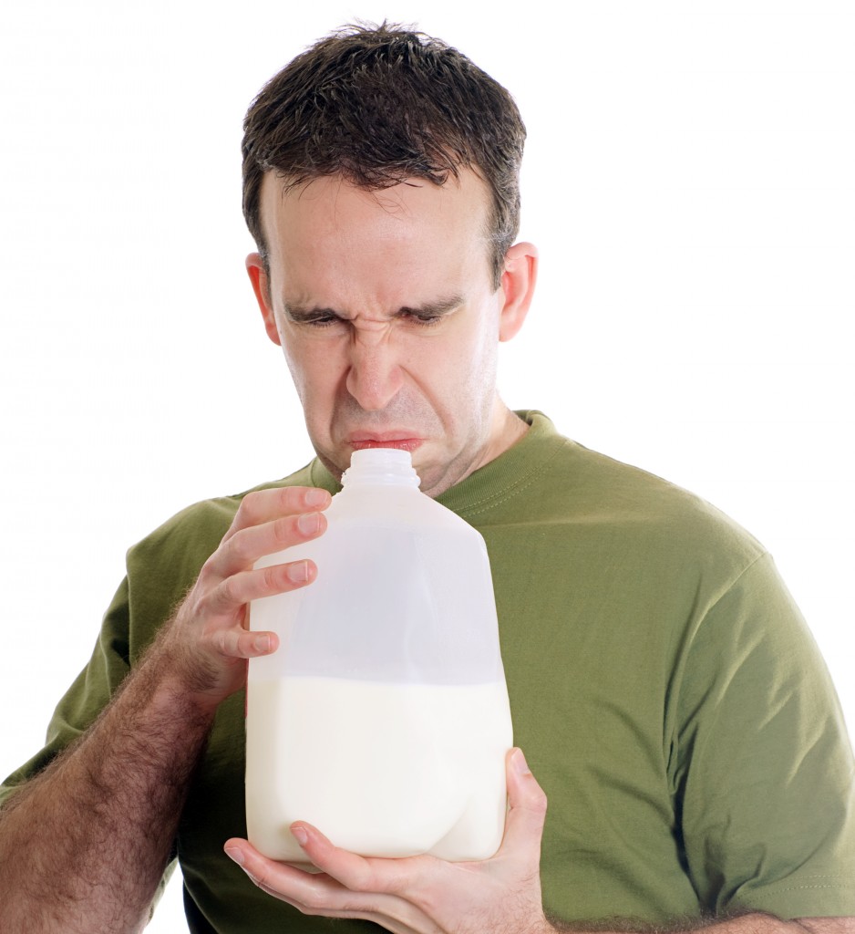 man sniffing spoiled milk