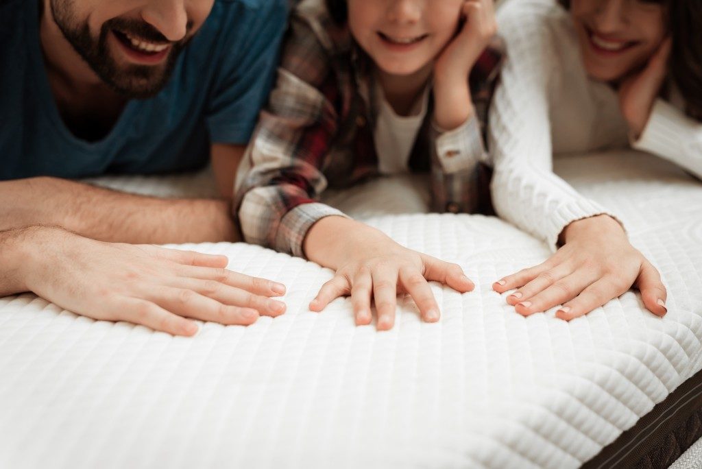 parents and child on the bed