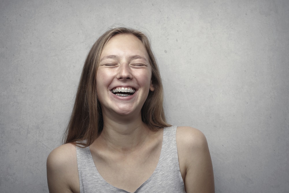 young woman with braces smiling
