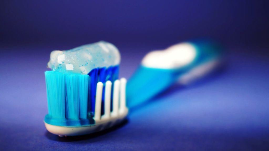 plastic toothbrush with toothpaste on it
