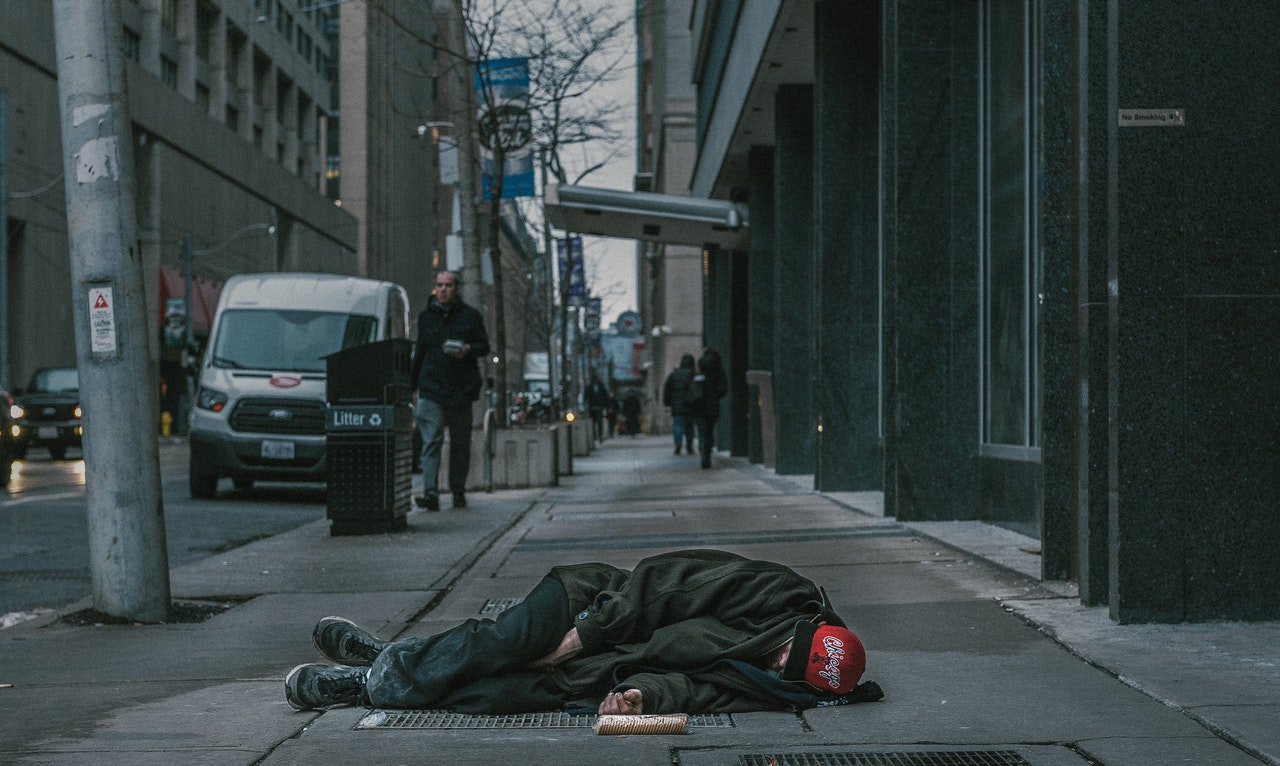 homeless person sleeping on the sidewalk