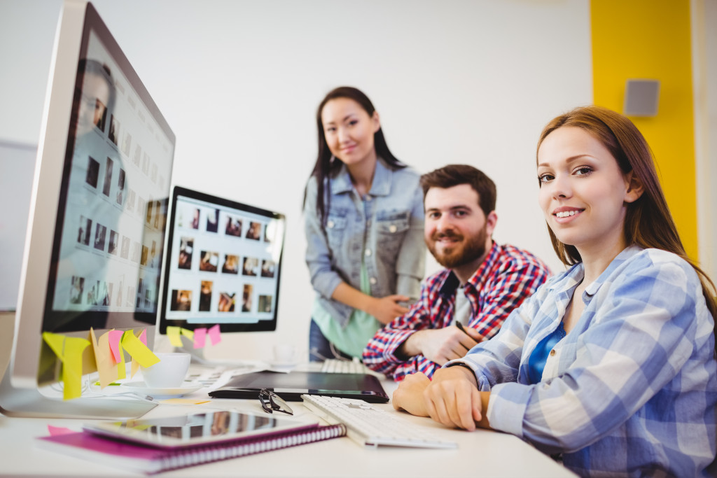 Three businesspeople looking at the camera