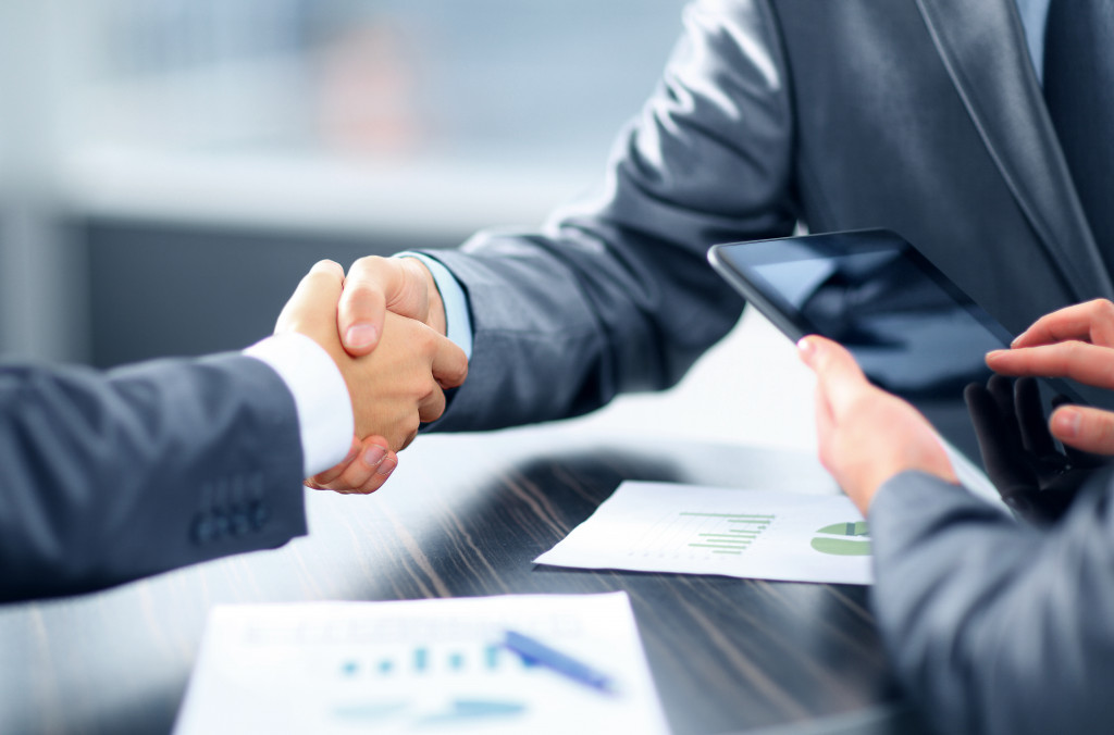 Businesspeople shaking hands in an office space