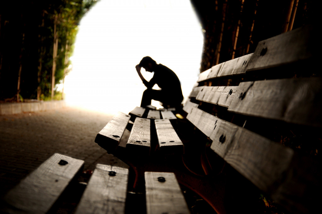 A man alone and sad in a tunnel