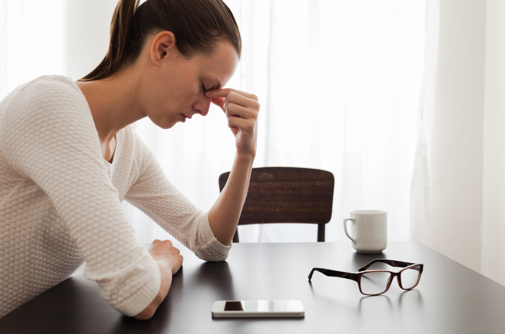 A stressed businesswoman sitting on the dining table