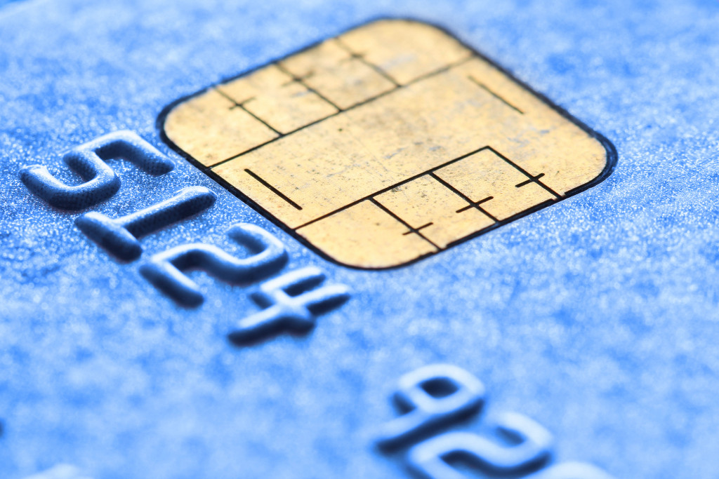 A blue credit card with a gold microchip