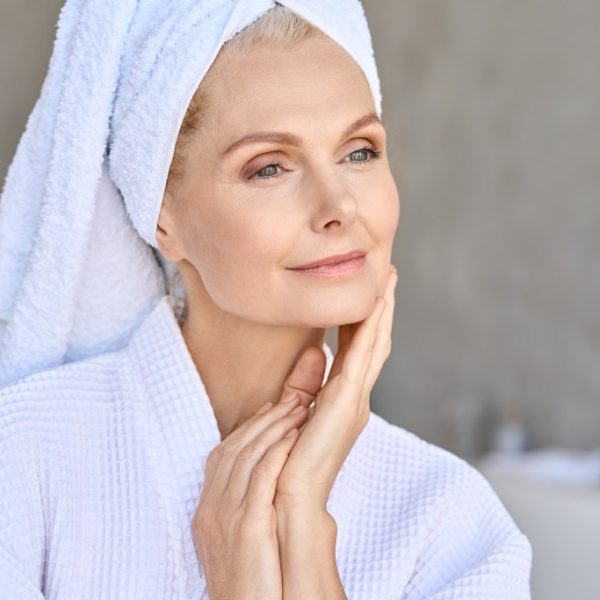 a senior woman looking fresh and clean wearing a bathrobe