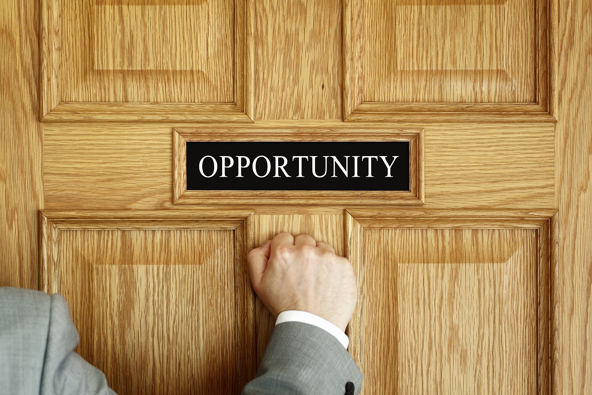 businessman knocking on a door to "OPPORTUNITY" office